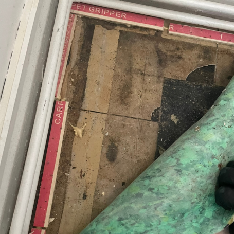 Close-up of vinyl floor tiles containing asbestos in Mansfield home